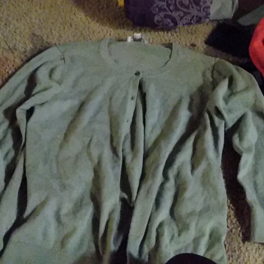 A button up army green sweater